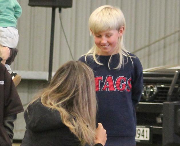 MC Laura Koot asks Liam McCullen, 9, how long he has been growing his prize-winning mullet.
