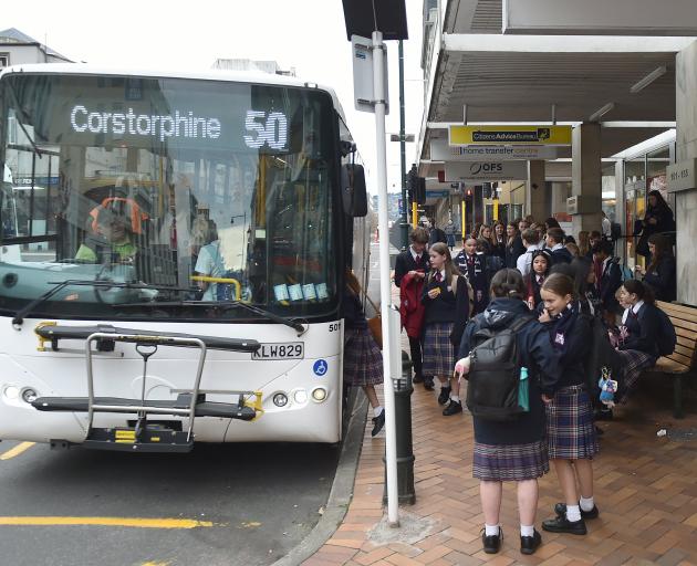 Secondary school students wait for the bus at the 151 Princes St stop in Dunedin yesterday. PHOTO...