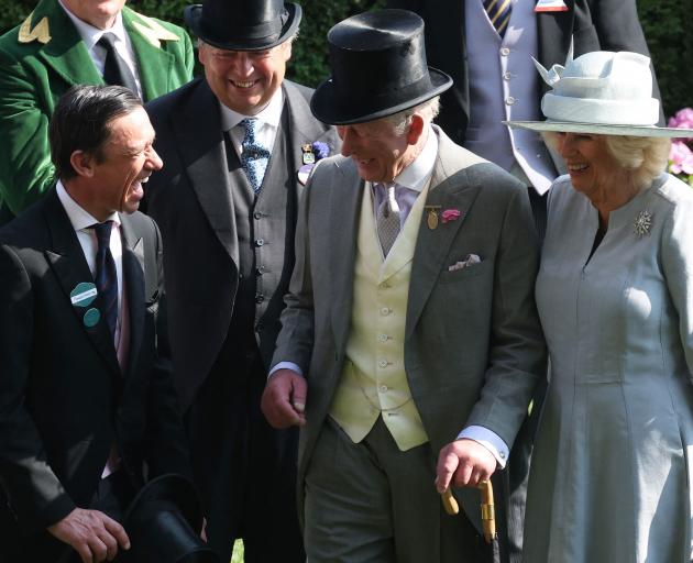 Royalty meets racing royalty ... King Charles and Queen Camilla share a joke with the king of...