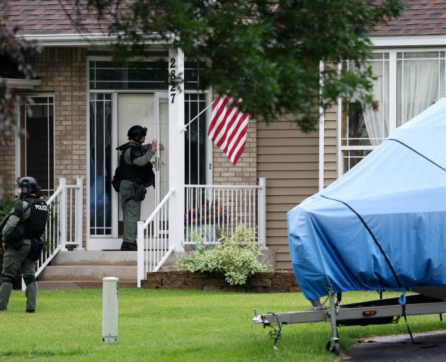 Officers canvas the neighborhood after what police said was a targeted shooting in the area...
