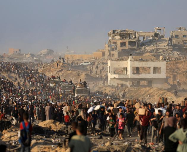Thousands of Palestinians gather to receive aid supplies in Beit Lahia, in the northern Gaza...