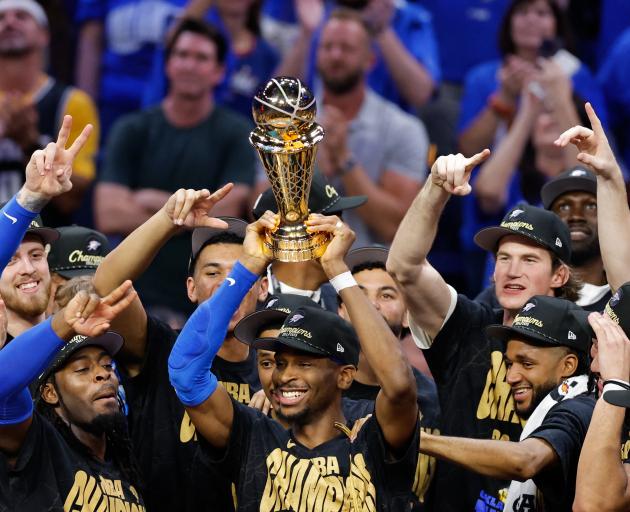 Oklahoma City Thunder players celebrate as Shai Gilgeous-Alexander lifts the Larry O'Brien...