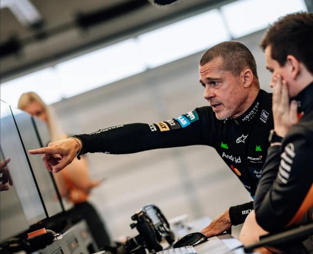 Brad Pitt looks at home during a test session with McLaren during which he drove one of the team...