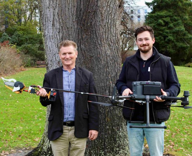 Prof Richard Green, left, and Dr Sam Schofield with the new chainsaw drone they’ve developed as...