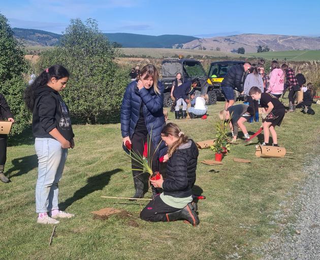 Recent visitors from Taieri College volunteer at Te Nohoaka o Tukiauau — Sinclair Wetlands, which...