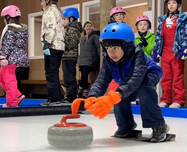 Goldfields School year 3 pupil Kianm Nerurkar gives curling a whirl during a class trip to Ice...