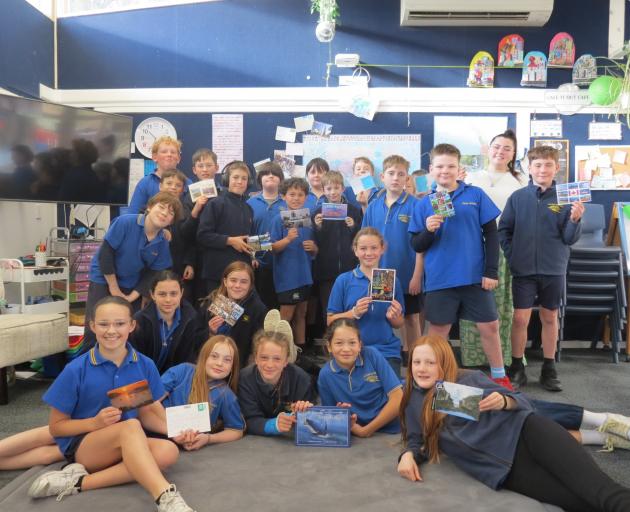 Clyde Primary School teacher Sydney Robertson and the year 6 and 7 Korimako class show off with...