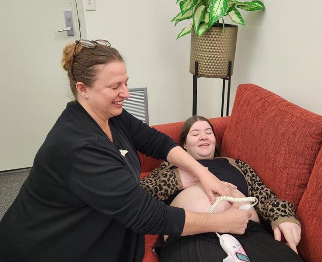 Dr Pauline Dawson checks the heartbeat of Oranga Wahine administrator Amy Wornin’s baby. This is...