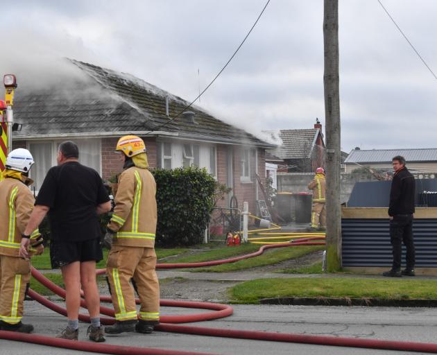 Smoke was visible coming from under the roof in a house fire last week. PHOTO: PIXSJ