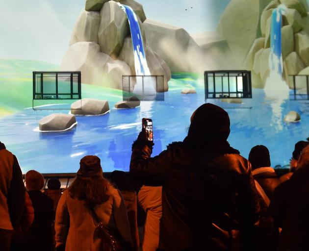 An image is projected on to the Tūhura Otago Museum building as part of a pre-dawn Matariki...