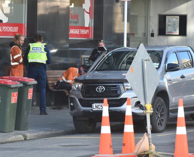 Police respond to reports of a man assaulting a pedestrian with his skateboard. Photo: Gregor...