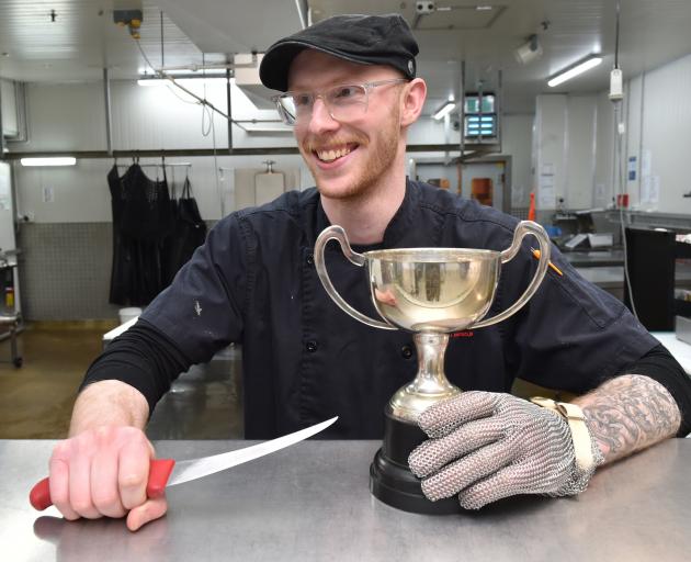 Gardens New World butcher Riley Hall, of Dunedin, with his trophy for winning the ANZCO Foods...