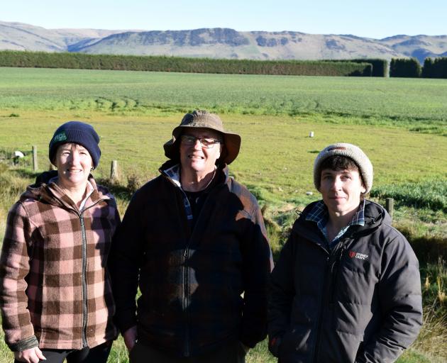 Ian and Sandra Orr and their son Brendon stand in front of the woodchip bioreactor on their farm...