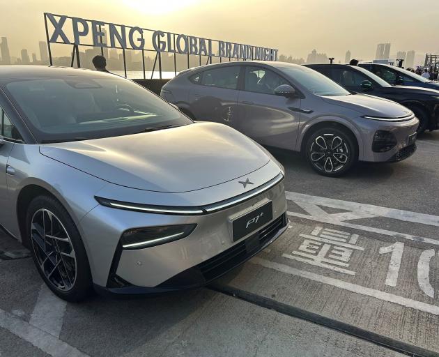 Chinese electric vehicle maker Xpeng displays its lineup of SUVs and sedans at an event in Hong...