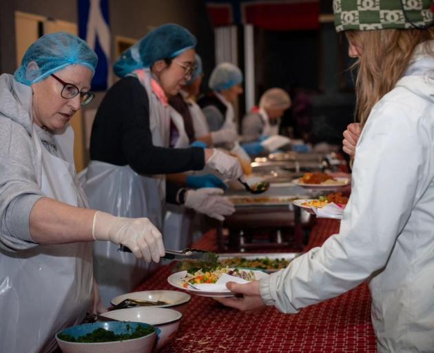 A volunteer serves a meal at a Paste Cafe night in 2023. PHOTO: SUPPLIED