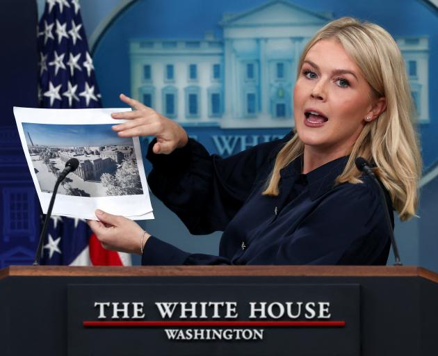 White House Press Secretary Karoline Leavitt holds an image of a rendering of the new White House...