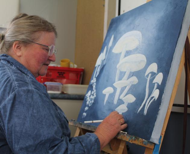 Susan Stevenson works on her painting at the Art for Leisure class at the Southern Institute of...