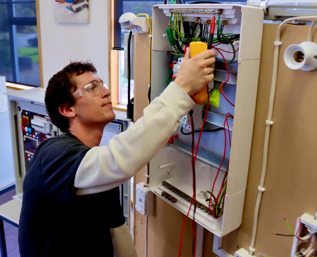 Otago Polytechnic student Finn Bowman checks connections on an electrical test panel. PHOTOS: SAM...