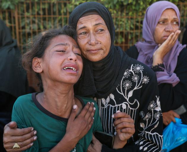 Mourners during the funeral of Palestinians killed by Israeli fire while trying to receive aid on...