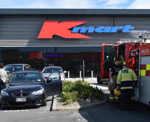 A Fire and Emergency New Zealand crew from St Kilda attends to a smoke-filled car after a battery...