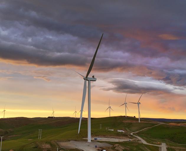 The sun breaks out over one of the turbines of the Kaiwera Downs wind farm, which is be near the...
