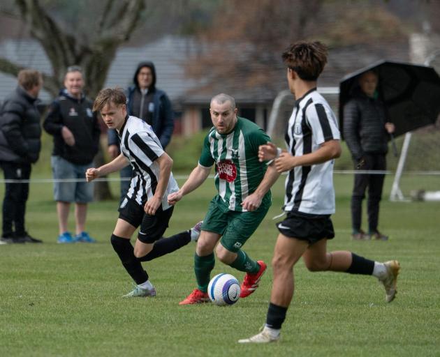 Halswell United striker Dan Ede drives at the FC Nelson defence during his side’s 3-1 win in the...