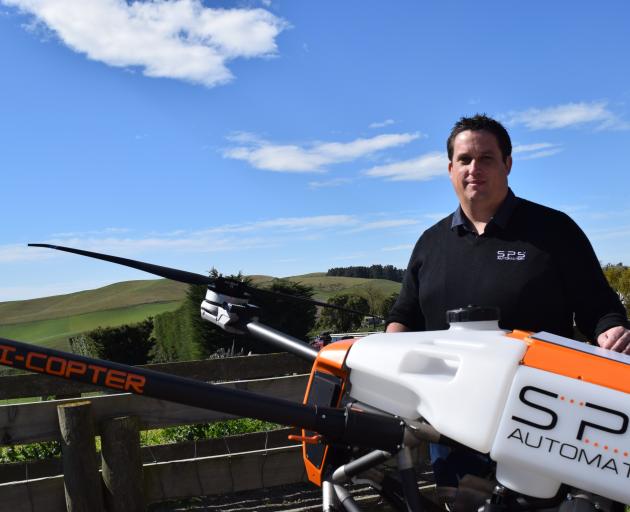 SPS Automation chief executive and technology officer Scott Spooner and an Agri-copter BFD 70 at...
