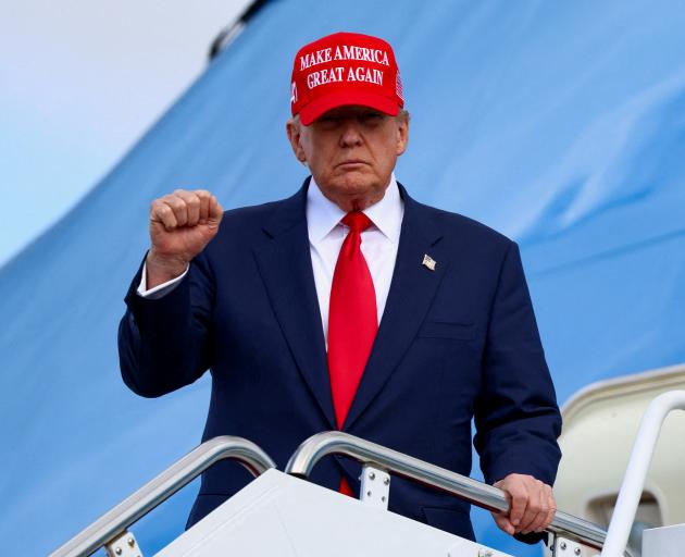 Donald Trump disembarks Air Force One following his recent trip to Asia. Photo: Reuters