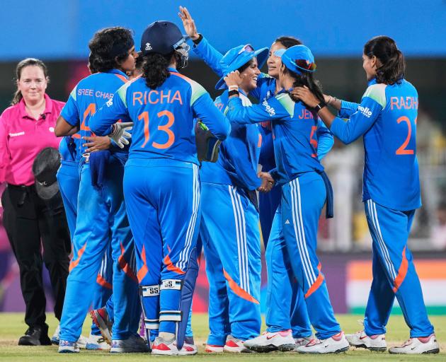 The Indian players celebrate after beating Sri Lanka in the opening match of the Women’s Cricket...