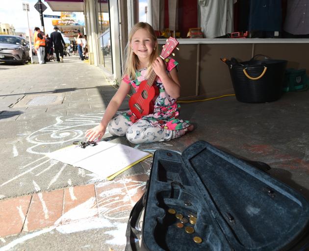 Up-and-coming busker Julia Knights, 7, plays the ukulele.