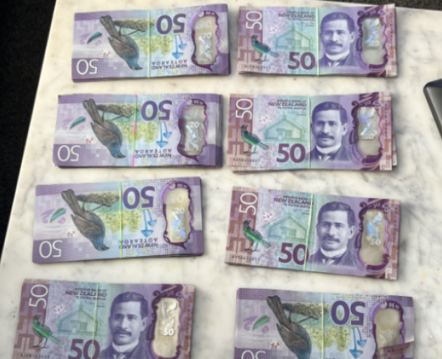 Police seized $9000 in cash during a search warrant. Photo: Police