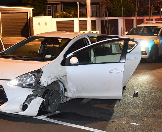 A car sits abandoned in Forbury Rd this morning after being driven through the city on sparking...