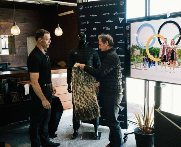New Zealand Olympic Committee summer Chef de Mission Nigel Avery (left) hands over the kakahu to...