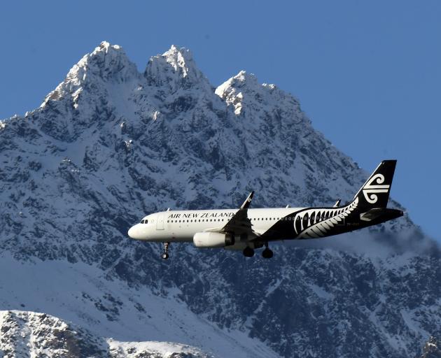 An Air New Zealand Airbus A320 plane passes the Remarkables as it heads in to land at Queenstown...