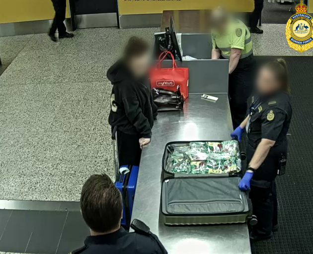 Australian Border Forces inspect one of the women's bags. Photo: Supplied