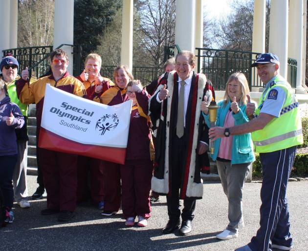 Holding the Olympic torch at Queens Park, Invercargill, before the 2022 Special Olympics are ...