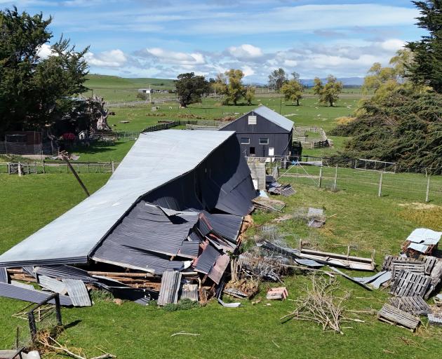 Damaged structures can be seen beside the Tuapeka Mouth road, with one shed down and another,...