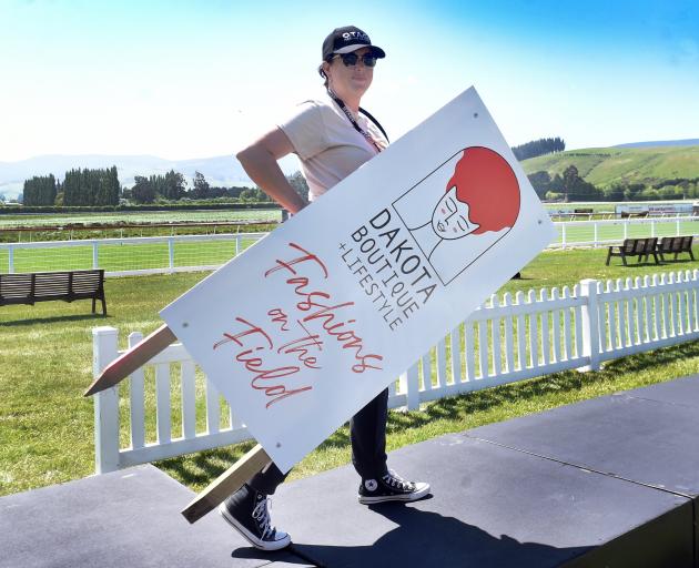 Otago Racing Club sales and marketing co-ordinator Samantha Wells helps set up the Fashions on...