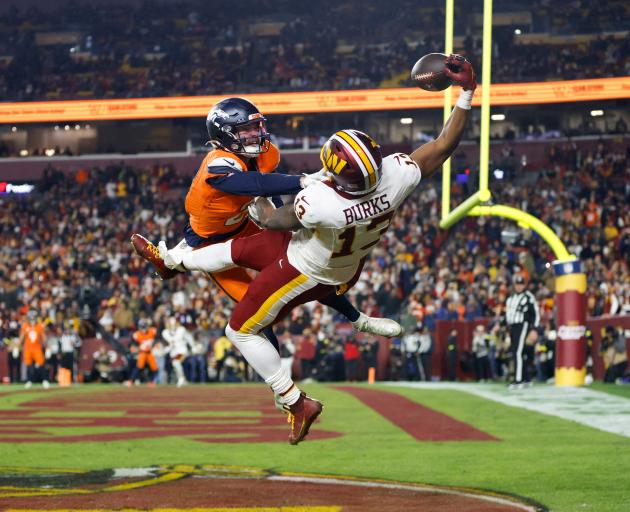 Washington Commanders wide receiver Treylon Burks makes a spectacular catch for a touchdown...
