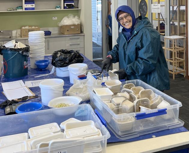 University of Otago master of science in human nutrition graduate Zahrah Hatraby collects food...