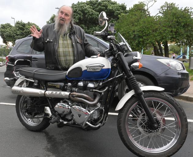 Southern Classics member Pat Wheatley stands beside his 2006 Triumph Scrambler 900 during a catch...
