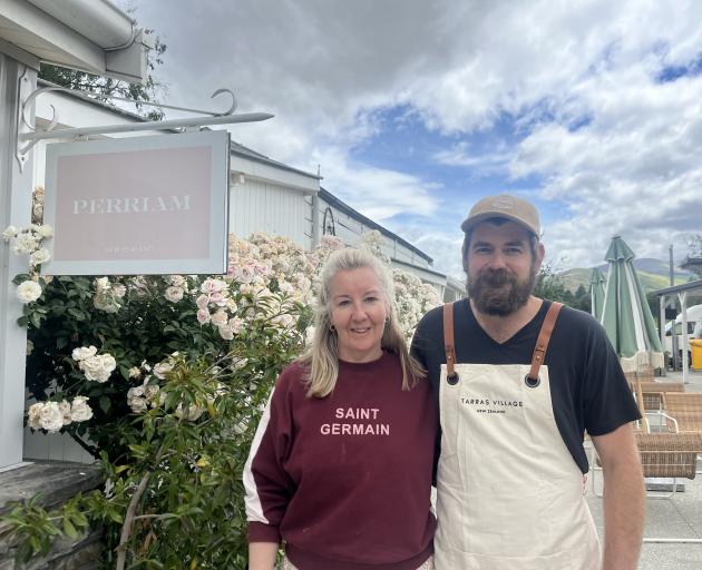 Christina Grant stands in front of her mother’s rose bushes with her husband Callum Grant at ...