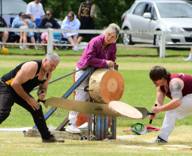 A team saw through a log at a previous Tūātapere Sports Day. Photo: Supplied / Dave Loudon