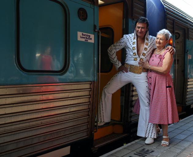 An Elvis tribute artist poses with a fan while boarding the Elvis Express in Sydney bound for...