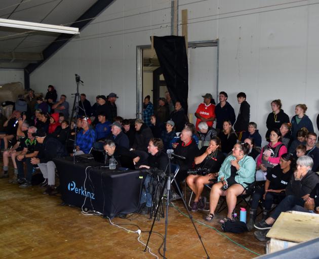 People watch the four-stand women’s eight-hours strongwool lamb record in the shearing shed at...