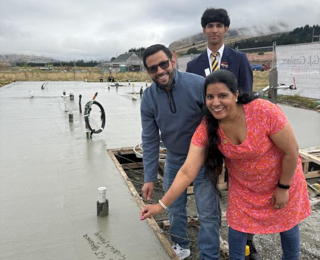 GJ Gardner Homes clients Guru Prasad and Asha Asha, with their son Divyam Nautival, after writing...