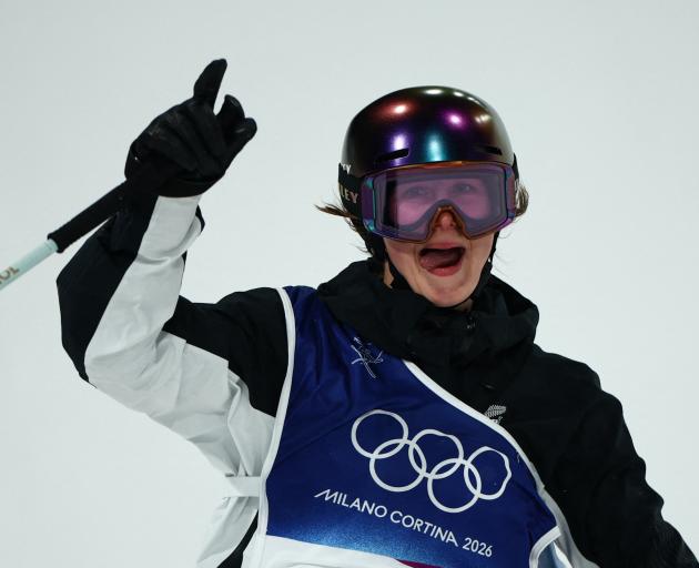 Mischa Thomas, of New Zealand, reacts after her first run in the Milano Cortina Olympics women's...