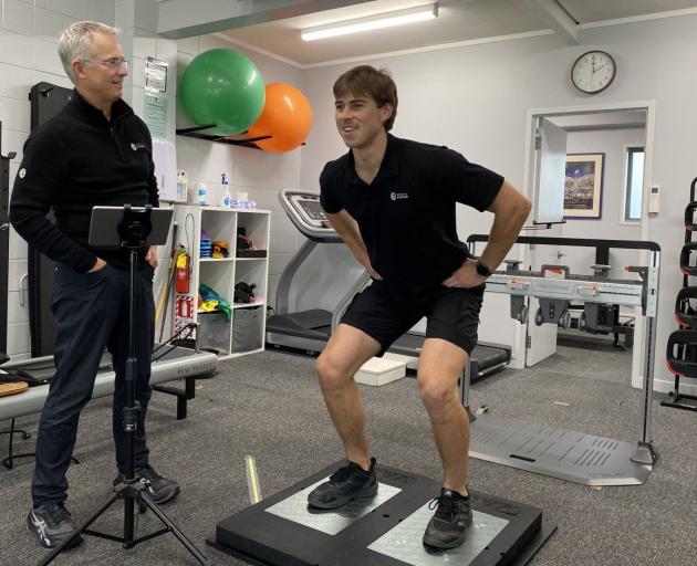 Roslyn Physiotherapy owner and physiotherapist Brett Woodley (left) puts physio Jonty Fleck...