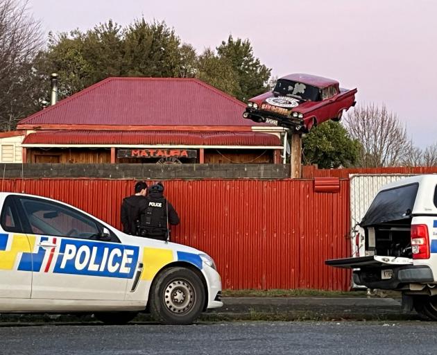 Police at the Mongrel Mob property in Albion St, Mataura, which the Crown is attempting to...