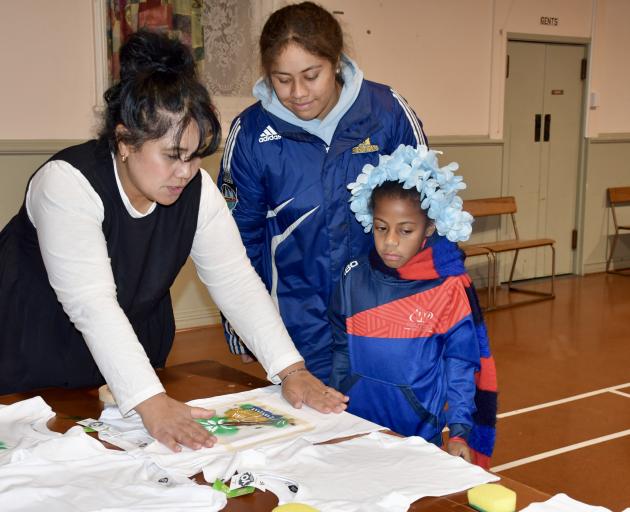 Oamaru Pacific Island Trust chairwoman Maiele Paia shows Toeafiafi Halalele (17) and Mailagi Lala...